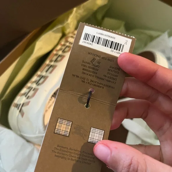 White low-top Burberry sneakers with signature check trim. - Picture 2 of 3